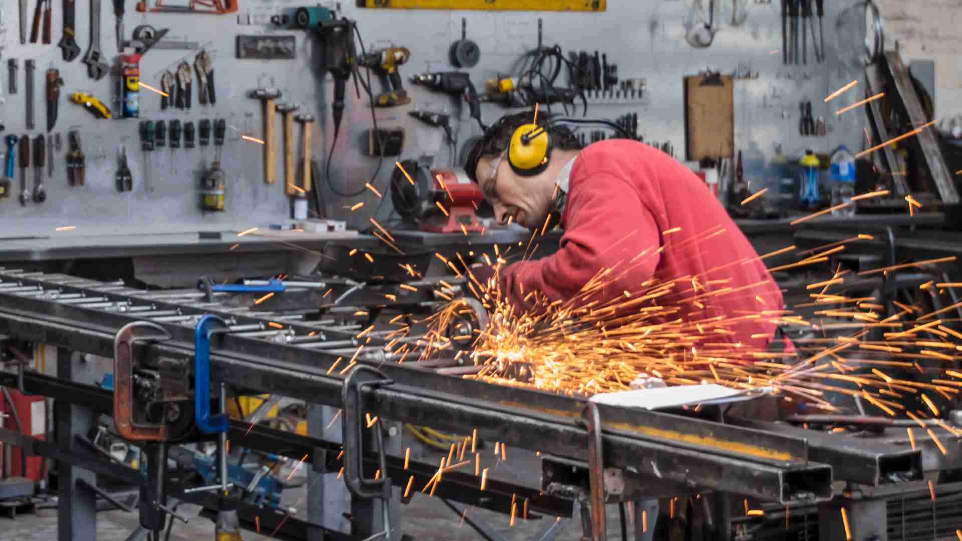 The production stage of custom iron railings, showing the transformation of raw mild steel into a finished architectural design.