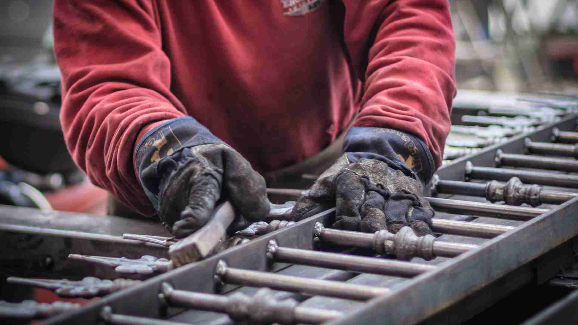 Skilled metalworkers hand-finishing bespoke steel railings, ensuring smooth joints and high-quality craftsmanship since 1990.
